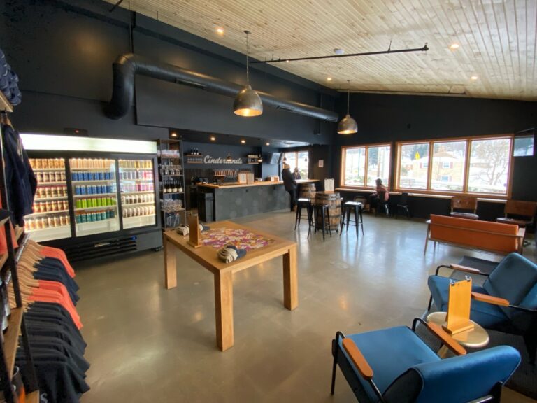 The beer fridge and merch wall inside the Wexford Taproom