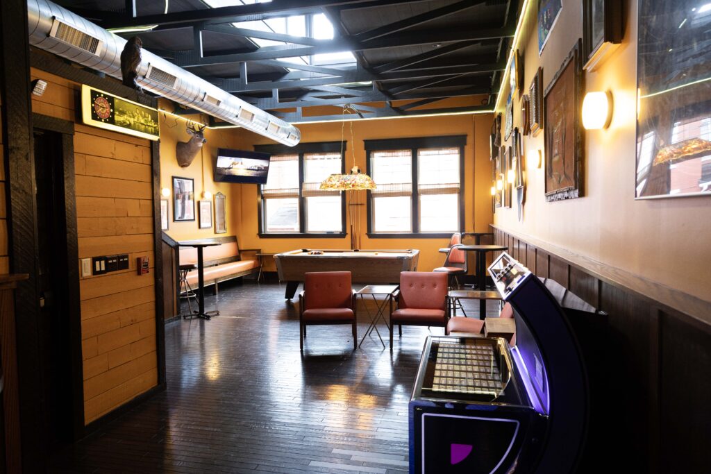 Lounge seating and the pinball machine in the Back Room at Long Story Short in Lawrenceville, Pittsburgh