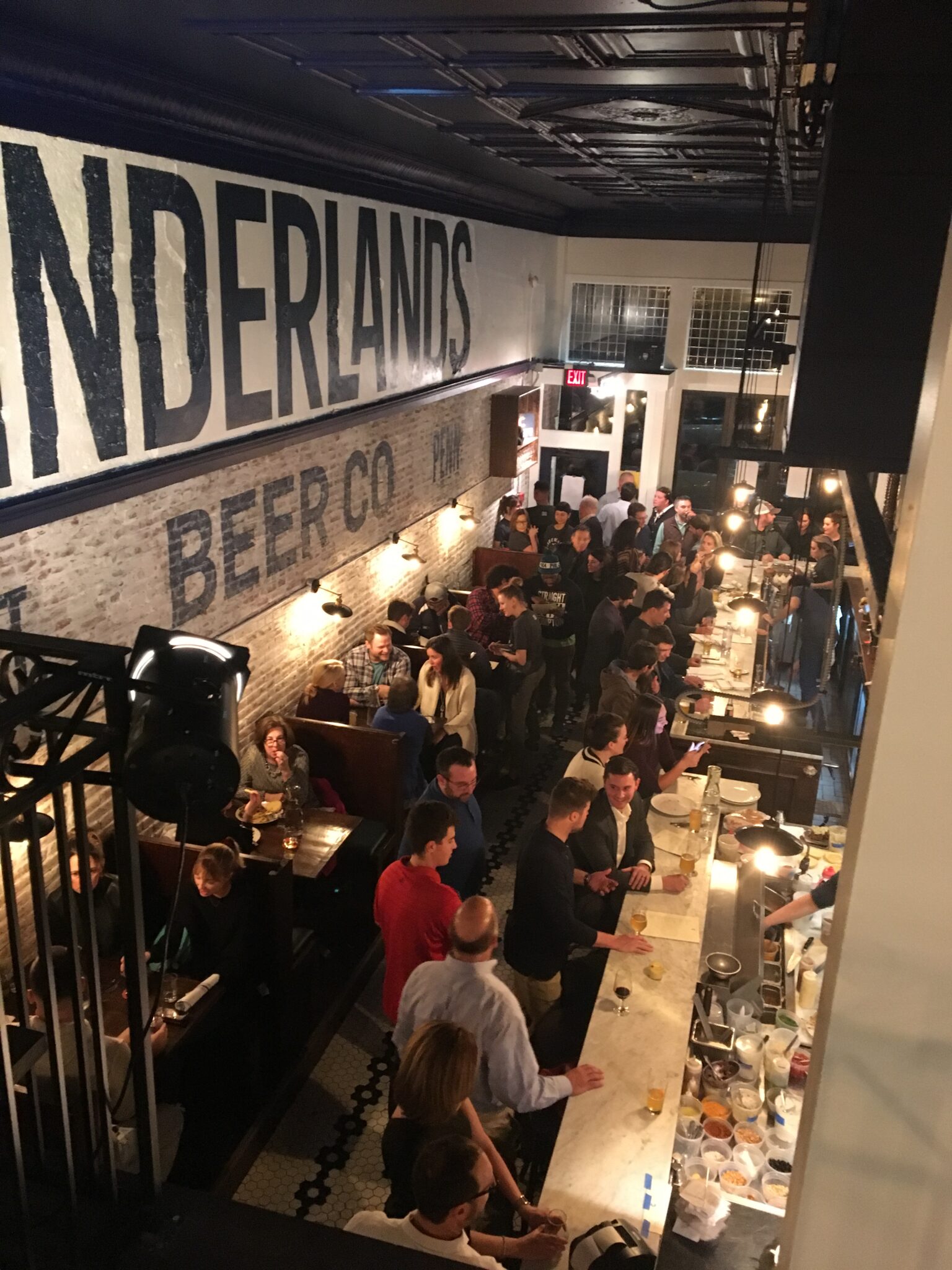 Opening night at 3705 Butler Street: a full bar under the Cinderlands Beer Co. sign