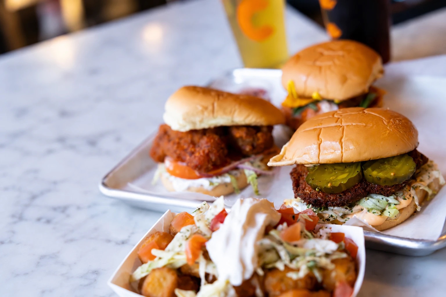 Fried chicken sandwiches and loaded tots with a Cinderlands beer at Long Story Short